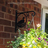 Ducks Hanging Basket Bracket The Ducks Hanging Basket Bracket by Black Fox Metalcraft Ltd, with its laser-cut duck design, beautifully displays colorful flowers. Mounted on a brick wall, it showcases intricate craftsmanship and modern design techniques.