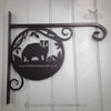 Badger Hanging Basket Bracket The "Badger Hanging Basket Bracket" from Black Fox Metalcraft Ltd features an intricate laser cut badger design with ferns, mounted on a white wall. Text includes "blackfoxmetalcraft.co.uk" and "Copyright Black Fox Metalcraft Ltd." Ideal for fans of traditional blacksmithing.