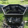 Hexagonal Firepit The Black Fox Metalcraft Ltd Hexagonal Firepit, with laser-cut wildlife and nature designs, exudes elegance on the grassy ground with stones behind it, capturing the essence of the majestic Scottish Highlands.