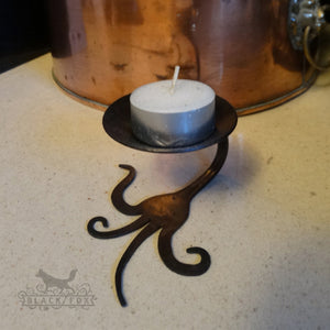 tea light holder forged from a reclaimed fork.