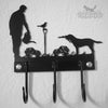 Gardener with Dog Coat Hooks The Gardener with Dog Coat Hooks by Black Fox Metalcraft Ltd features laser-cut silhouettes of a person watering plants, a bird on a lamppost, and a dog, with three decorative hooks below.