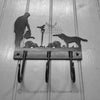 Gardener with Dog Coat Hooks The Gardener with Dog Coat Hooks by Black Fox Metalcraft Ltd features decorative laser cut silhouettes of a person with a cat, two dogs, and birds.