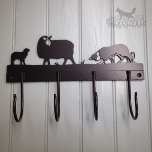Set of hand forged hooks with laser cut sheep and collie design.
