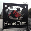 Swallows and Wildflowers Sign The "Swallows and Wildflowers Sign" by Black Fox Metalcraft Ltd displays an English wildflower design with swallow silhouettes in flight, adorned with butterflies and flowers, with red flowers peeking through cutouts against a stone building and lush greenery.