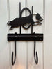 The Dog Agility Hooks - Border Collie by Black Fox Metalcraft Ltd features two hand-forged black metal hooks with a leaping dog silhouette, perfect for agility fans and as a unique personalised dog gift.