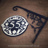 Decorative house number sig '55' with ornate design and a metal hand forged bracket, branded 'Black Fox Metal Craft'.