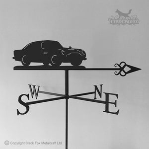 Silhouette of a Black Fox Metalcraft Ltd Aston Martin DB5 Weathervane featuring directional indicators marked S, W, E, and N—a sophisticated accent for any classic car enthusiast.