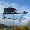 Austin 7 Chummy weathervane photographed against a bright morning sky.