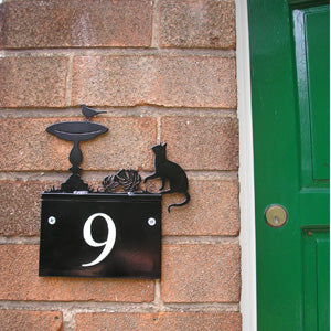 Decorative house number sign featuring a cat and bird design.