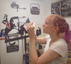 Jenny Gilding the details on a George and Dragon weathervane using 23.5 carat gold leaf.