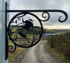 Decorative metal bracket with a bee design against a scenic background