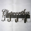 The Black Fox Metalcraft Ltd Industrial Style Coat Hooks feature four sturdy riveted hooks, perfect for dog leads, with “Clatworthy” elegantly written in cursive above the hooks.