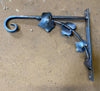 Ivy hanging basket bracket, hand forged by black fox metalcraft. Shown here just welded and cooling on the workshop floor.
