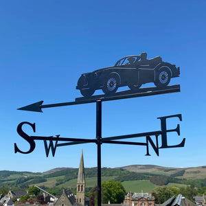 Jaguar XK40 weathervane, featuring a driver and passenger, photographed in the Scottish Borders with beautiful summer sky background.