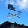 Land Rover 90 weathervane with a blue sky background, mounted to the side of a shed.