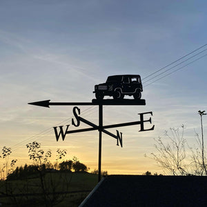 A custom-designed Landrover Defender 90 Weathervane by Black Fox Metalcraft Ltd points west, silhouetted against a sunset sky. 