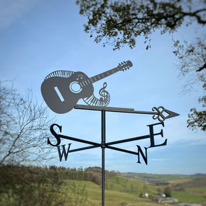 This delightful weathervane, named the Guitar and Piano Weathervane by Black Fox Metalcraft Ltd, features a rust-resistant design with a charming guitar and musical note motif. It elegantly withstands the elements while indicating the cardinal directions against a picturesque countryside backdrop, creating a harmonious blend of music and nature.