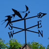 Swallows weathervane blue sky