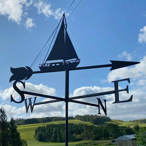 Yacht weathervane by Black Fox Metalcraft photographed against a blue sky. 