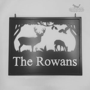 Laser cut swinging sign with Deer in the woods design.
