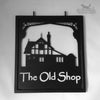 Bespoke swinging sign design featuring a home converted from an old shop.