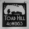 Hanging sign featuring Mr. Toad and his car.
