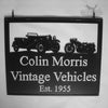 A hanging sign from Black Fox Metalcraft Ltd reads "Vintage Vehicles Est. 1955" with silhouettes of a vintage car and motorcycle, perfectly capturing the essence of a classic car restoration company.